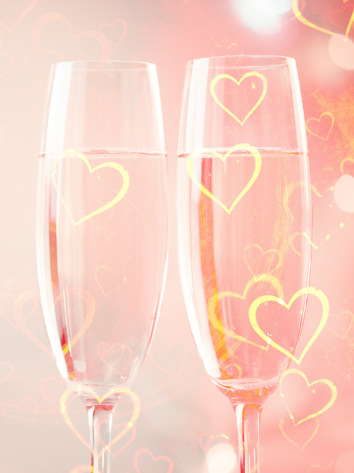 Champagne Toast BBW Canada | Two champagne flutes with heart designs on a soft pink background
