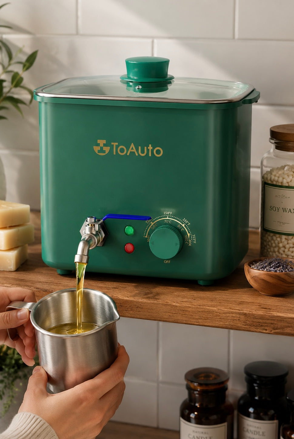Green ToAuto wax melter with a person pouring liquid into a metal cup on a wooden surface.