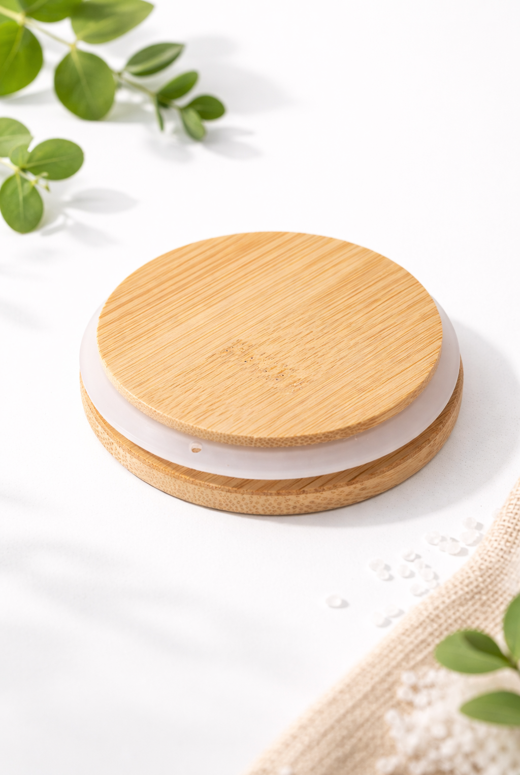 bamboo lid on a light surface with greenery