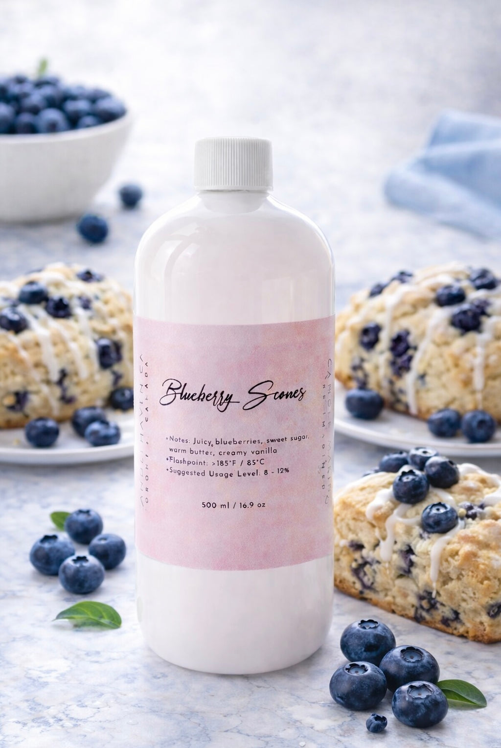 Bottle of 'Blueberry Scones' candle fragrance oil by candlehaven with blueberries and blueberry muffins in the background