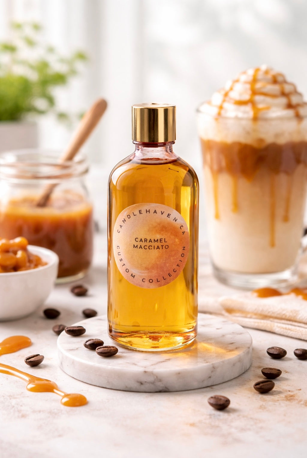 Bottle of Caramel Macchiato fragrance oil on a marble coaster with coffee beans and a coffee drink in the background.