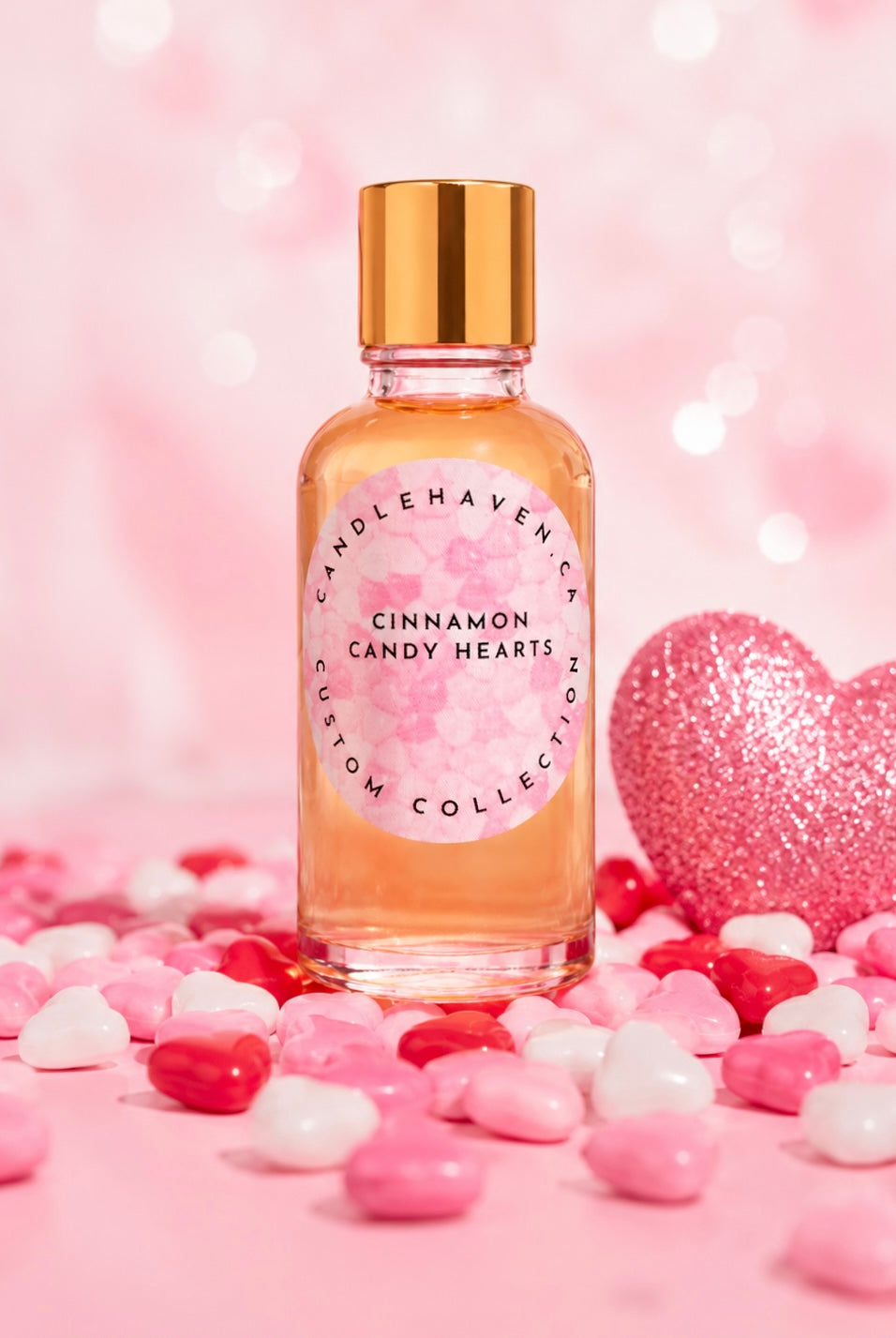 Bottle of 'Cinnamon Candy Hearts' fragrance oil by candlehaven with heart shaped candies on a pink background