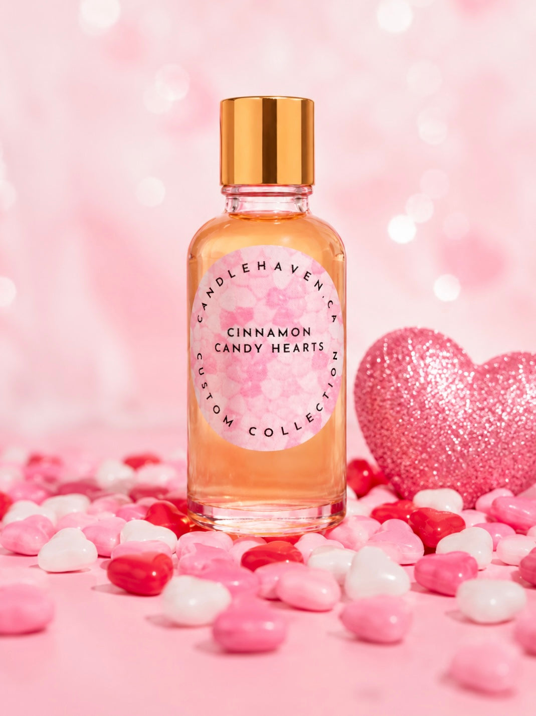 Bottle of 'Cinnamon Candy Hearts' fragrance oil by candlehaven with heart shaped candies on a pink background