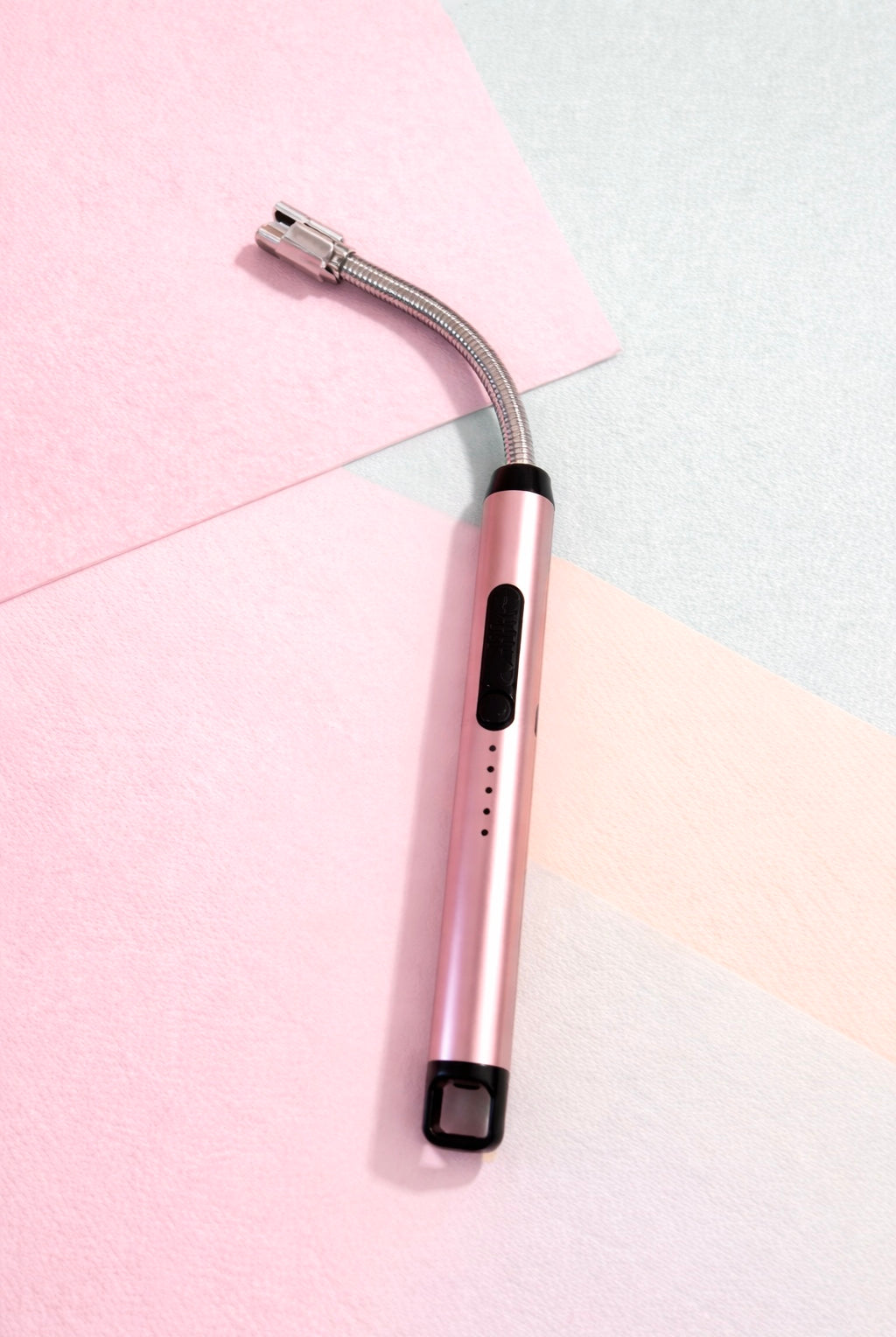 electric lighter with a curved silver head design on a colorful background