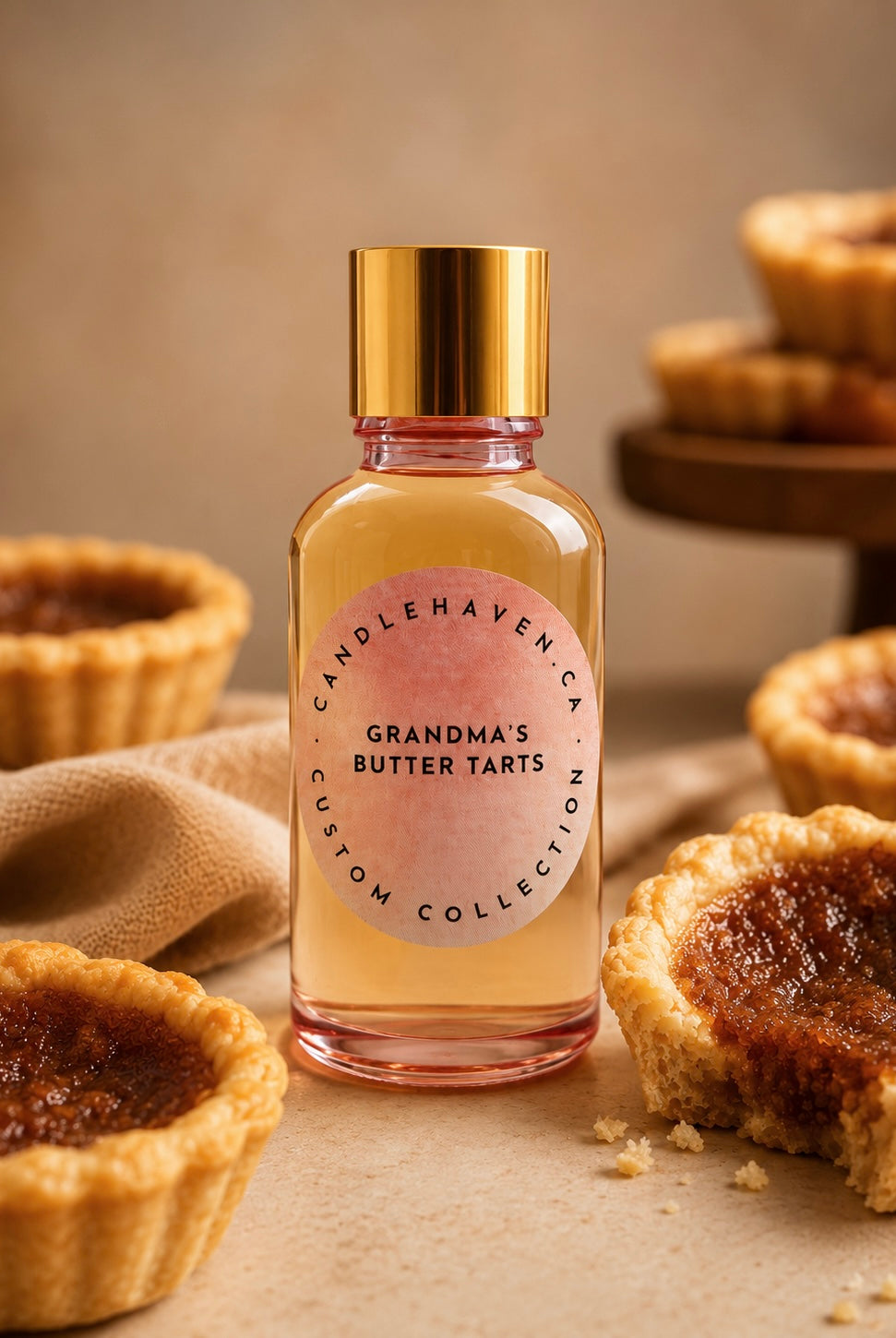 Bottle of 'Grandma's Butter Tarts' fragrance oil for candle making with butter tarts in the background
