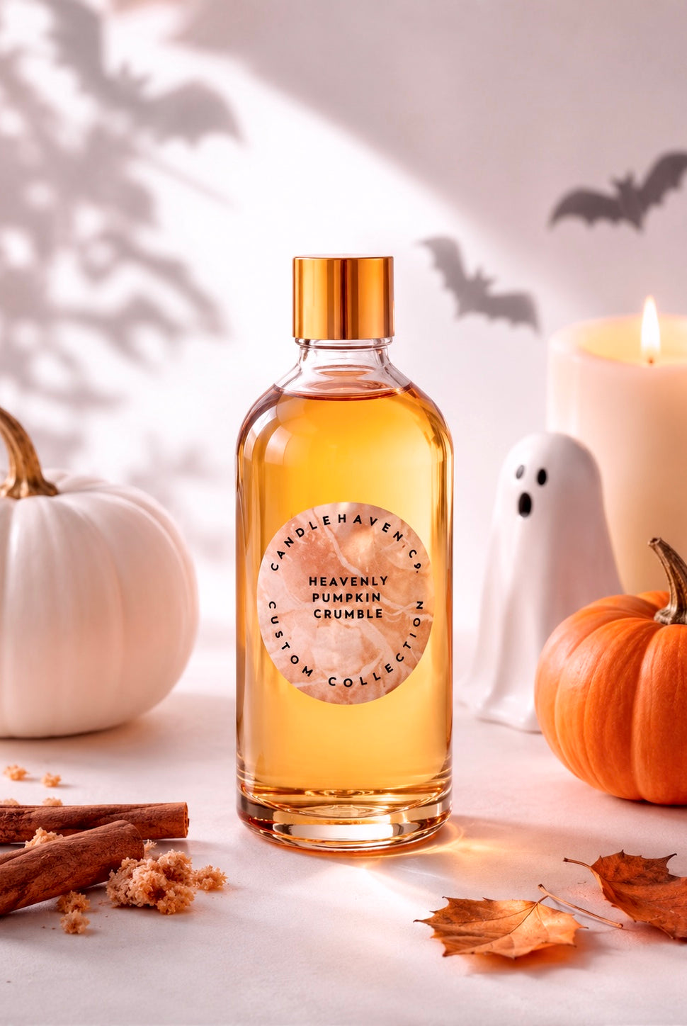 Bottle of 'Heavenly Pumpkin Crumble' fragrance oil for candle making with pumpkins, a ghost, and cinnamon sticks on a light background.