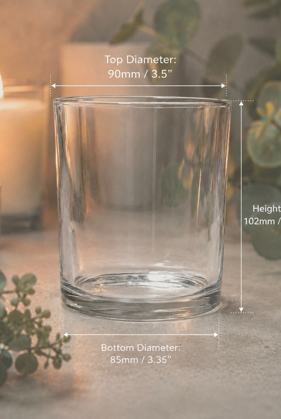 Clear glass candle holder with dimensions labeled on a neutral background