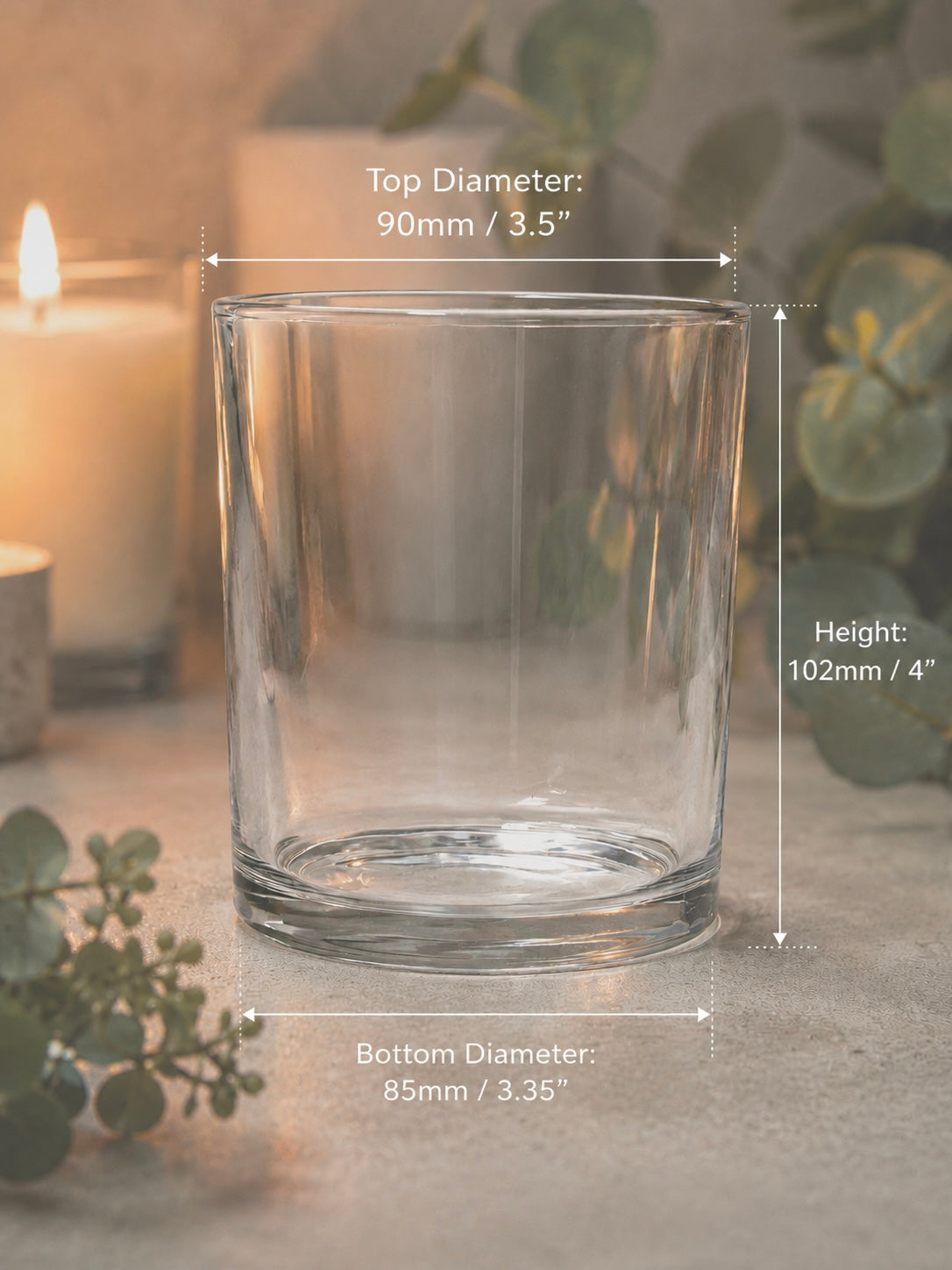 Clear glass candle holder with dimensions labeled on a neutral background