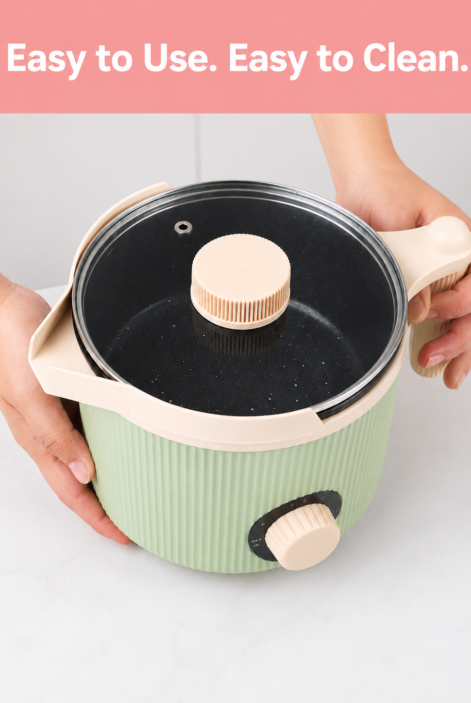 Green electric wax melter with black interior and wooden handles, held by a person