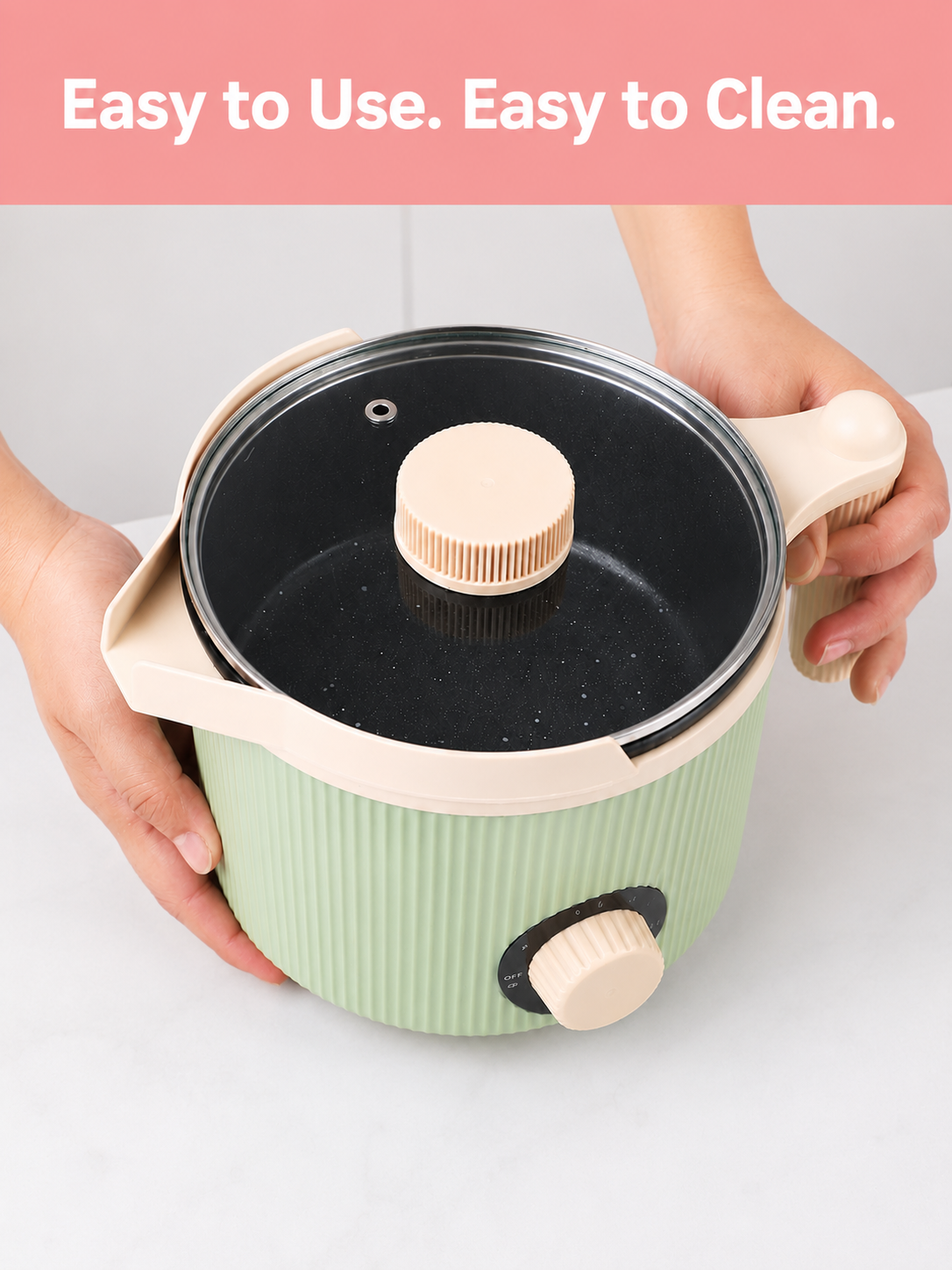 Green electric wax melter with black interior and wooden handles, held by a person