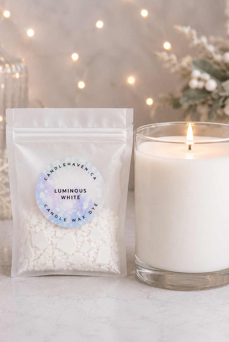 White wax dye chips used in candle making with a white candle beside on a light background
