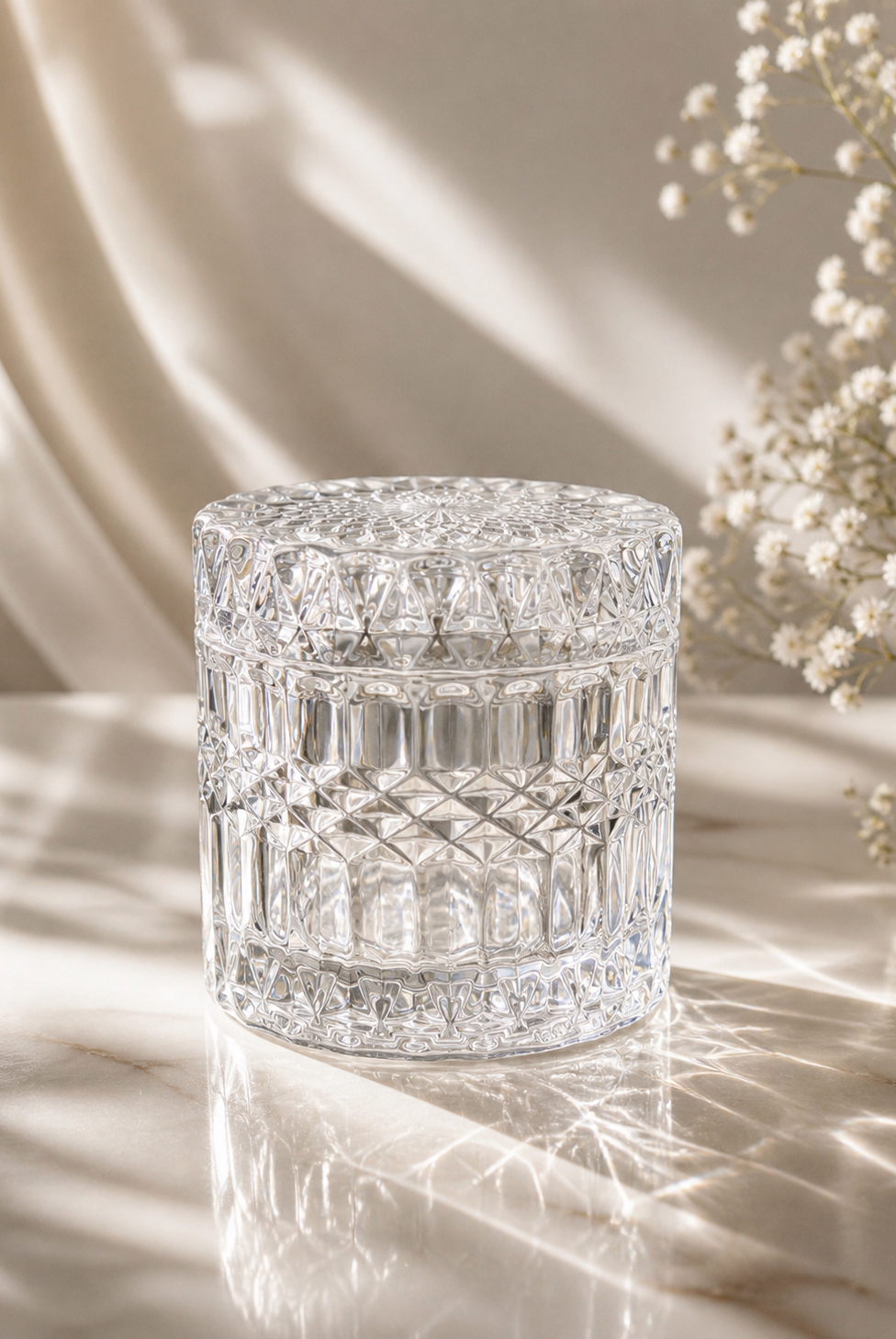 Geo cut clear jar with lid on a light coloured background