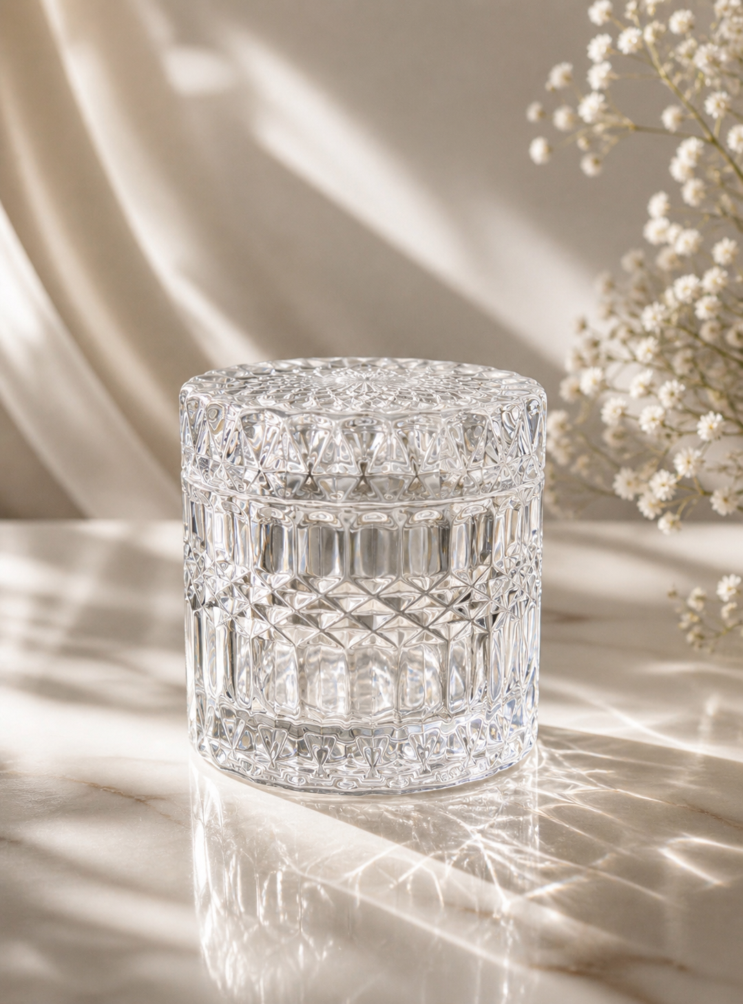 Geo cut clear jar with lid on a light coloured background