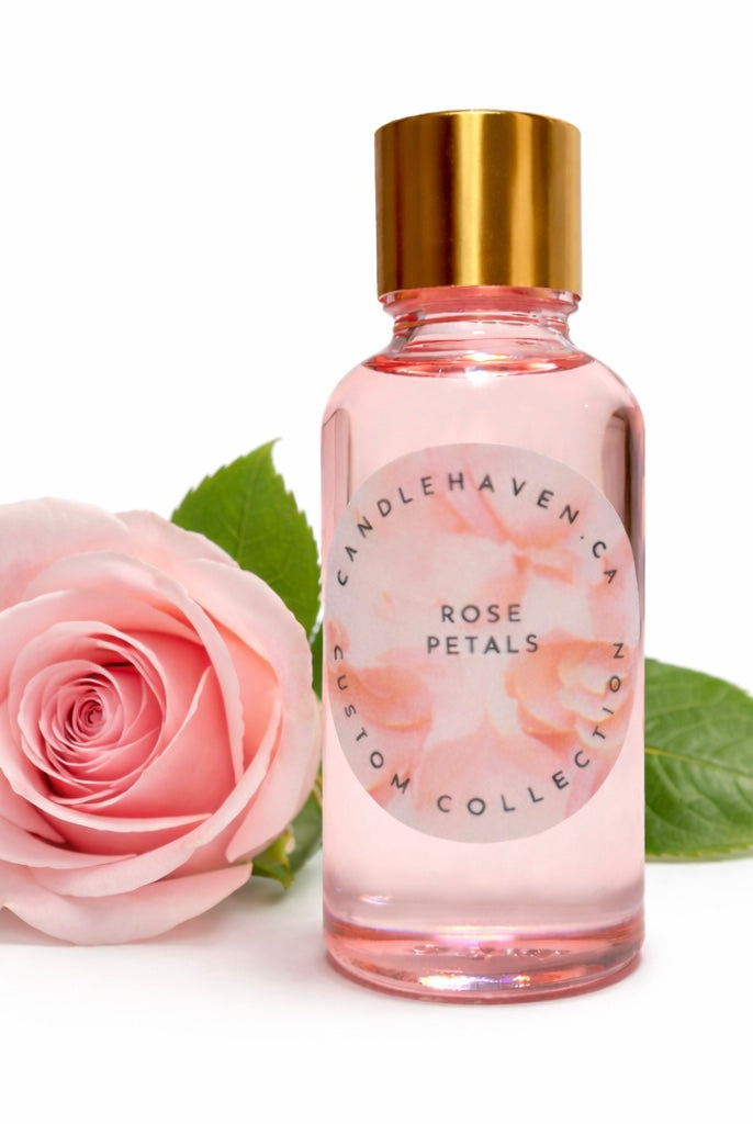 Bottle of Candle Haven 'Rose Petals' with a pink rose and green leaves on a white background