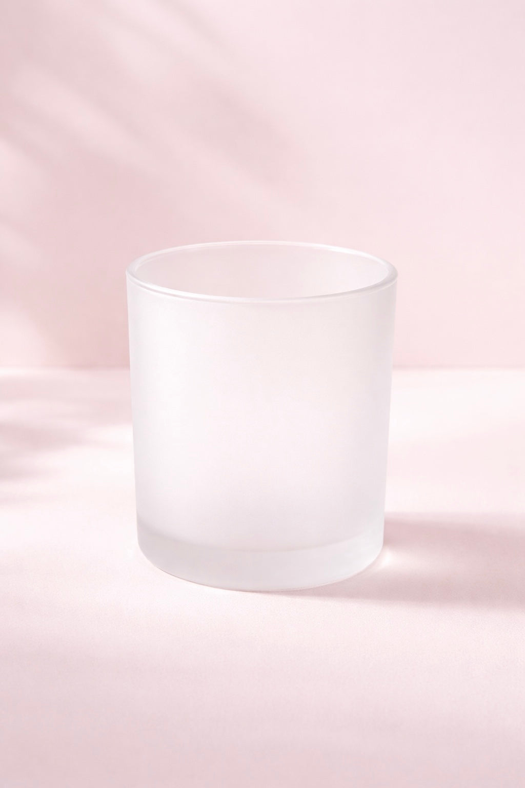 Frosted glass candle jar on a pink background | this jar is used in container candle making