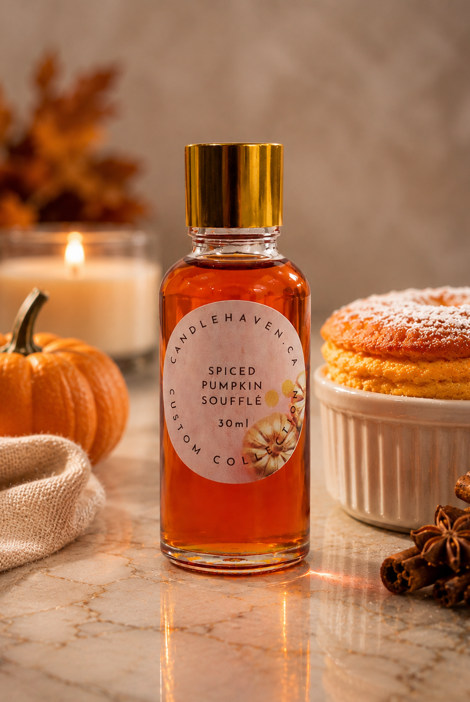Bottle of spiced pumpkin souffle fragrance oil with a pumpkin, candle, and dessert in the background.