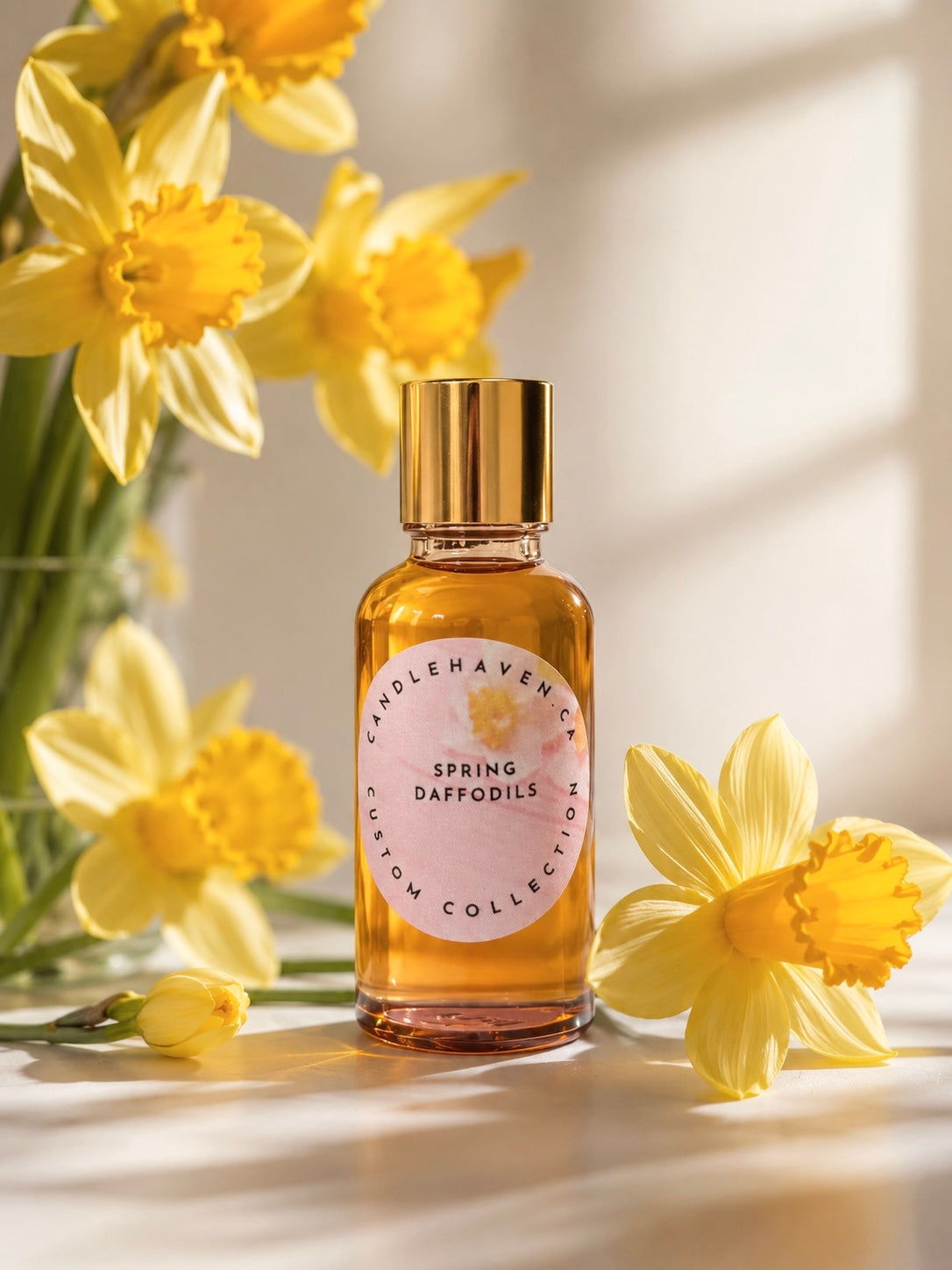 Spring Daffodils fragrance oil bottle by candlehaven.ca used in candle making on a light background with daffodils.