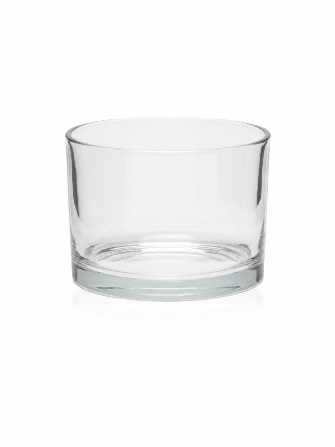Clear glass candle vessel on a white background