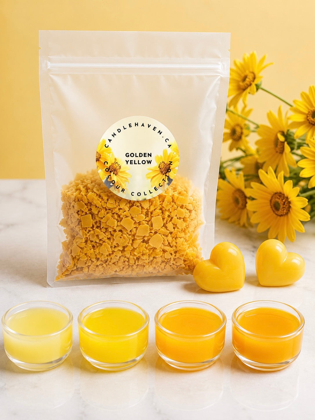 Packaged wax dye chips for candle making labeled 'Golden Yellow' with yellow flowers and small containers of yellow wax on a light background.