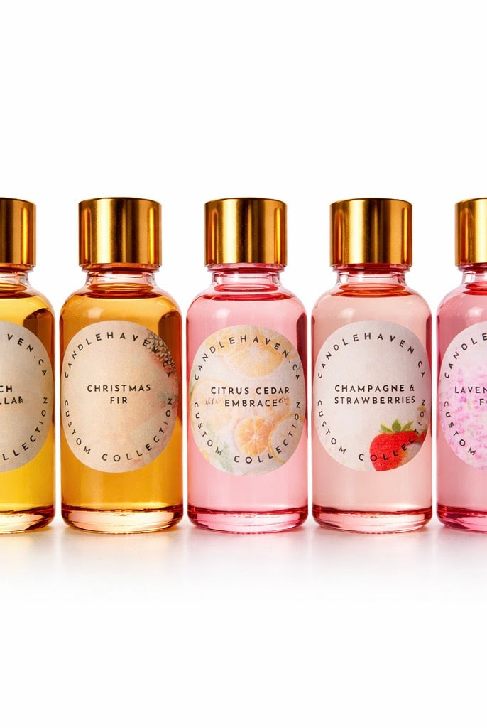 Five bottles of Candlehaven fragrance oils for candle making with gold caps on a white background