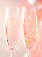 Champagne Toast BBW Canada | Two champagne flutes with heart designs on a soft pink background