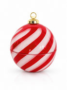 A glossy red and white shaped candy cane themed Christmas ornament shaped like a spherical container that is used for candle making with a gold hanging loop at the top, shown on a clean white background.