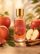 Bottle of 'Apple Cinnamon Delight' fragrance oil by candlehaven with apples and cinnamon sticks on a wooden surface