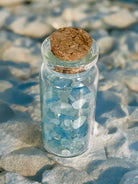 Aquamarine mini chips in a bottle used in candle making 