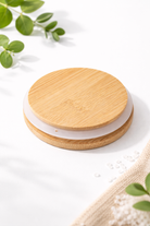 bamboo lid on a light surface with greenery