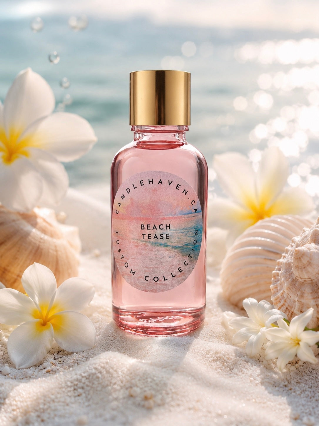Pink bottle of Candle Haven Beach Tease fragrance oil for candle making on sand with flowers and shells