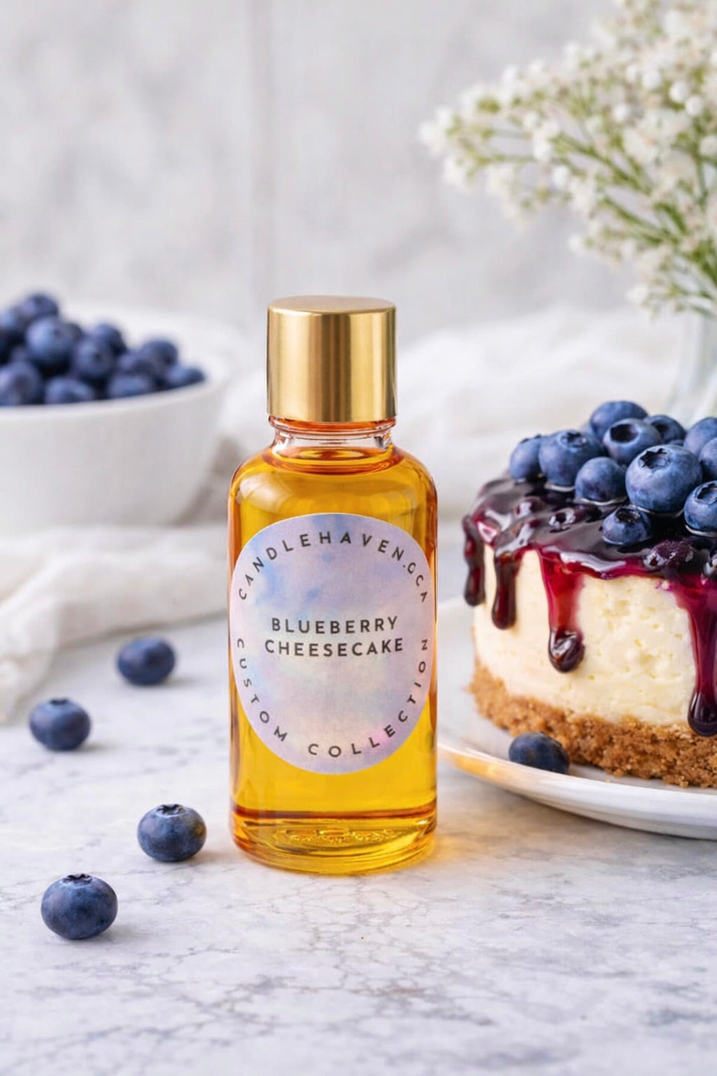 Bottle of Candlehaven Blueberry Cheesecake candle fragrance oil on a marble surface with blueberries and a cheesecake.