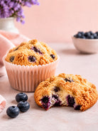 Blueberry Muffins and blueberry muffin tops on a pink background depicting a blueberry muffin tops fragrance oil