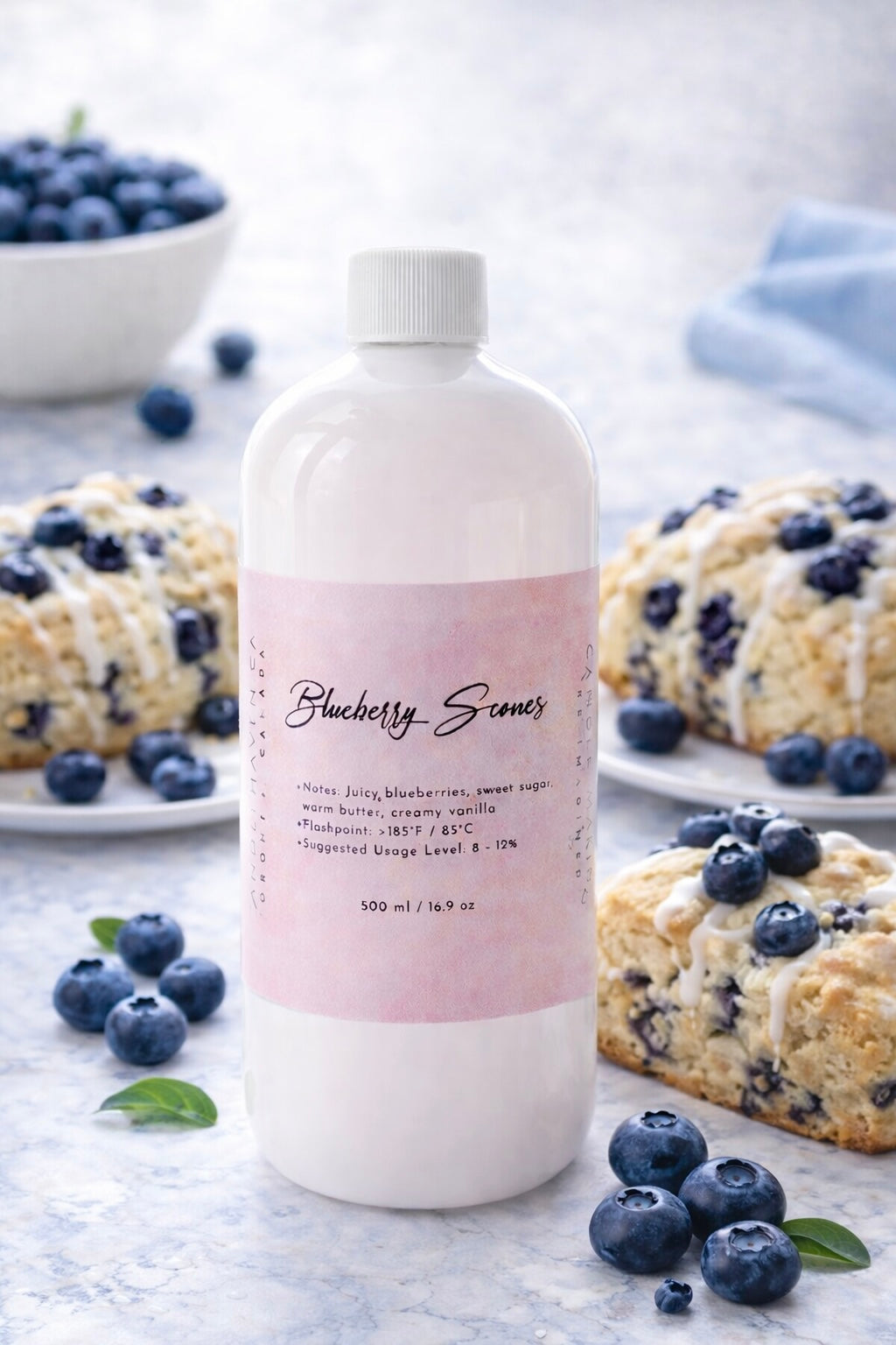 Bottle of 'Blueberry Scones' candle fragrance oil by candlehaven with blueberries and blueberry muffins in the background
