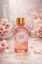 Bottle of Cherry Blossom Blush fragrance oil from Candlehaven.ca with cherry blossoms and a candle in the background.