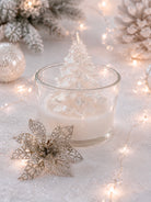 Decorative candle with a small tree inside, surrounded by festive lights and ornaments.
