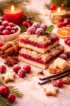 Cranberry sugar fragrance oil | Stack of cranberry bars with garnishes on a festive background with candles and cranberries.