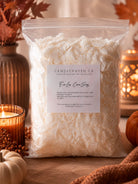 A clear plastic bag filled with white wax sits on a wooden surface, labeled Candlehaven Co. EcoLux Coco Soy Wax