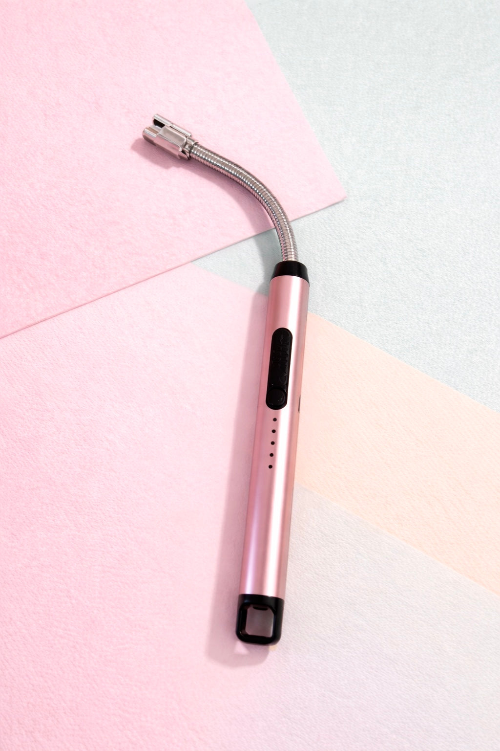 electric lighter with a curved silver head design on a colorful background