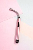 electric lighter with a curved silver head design on a colorful background