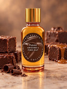 A glass bottle of Candlehaven.ca Fudge Around & Find Out scented candle wax with a gold cap, styled on a marble surface with chocolate brownies and chocolate curls.