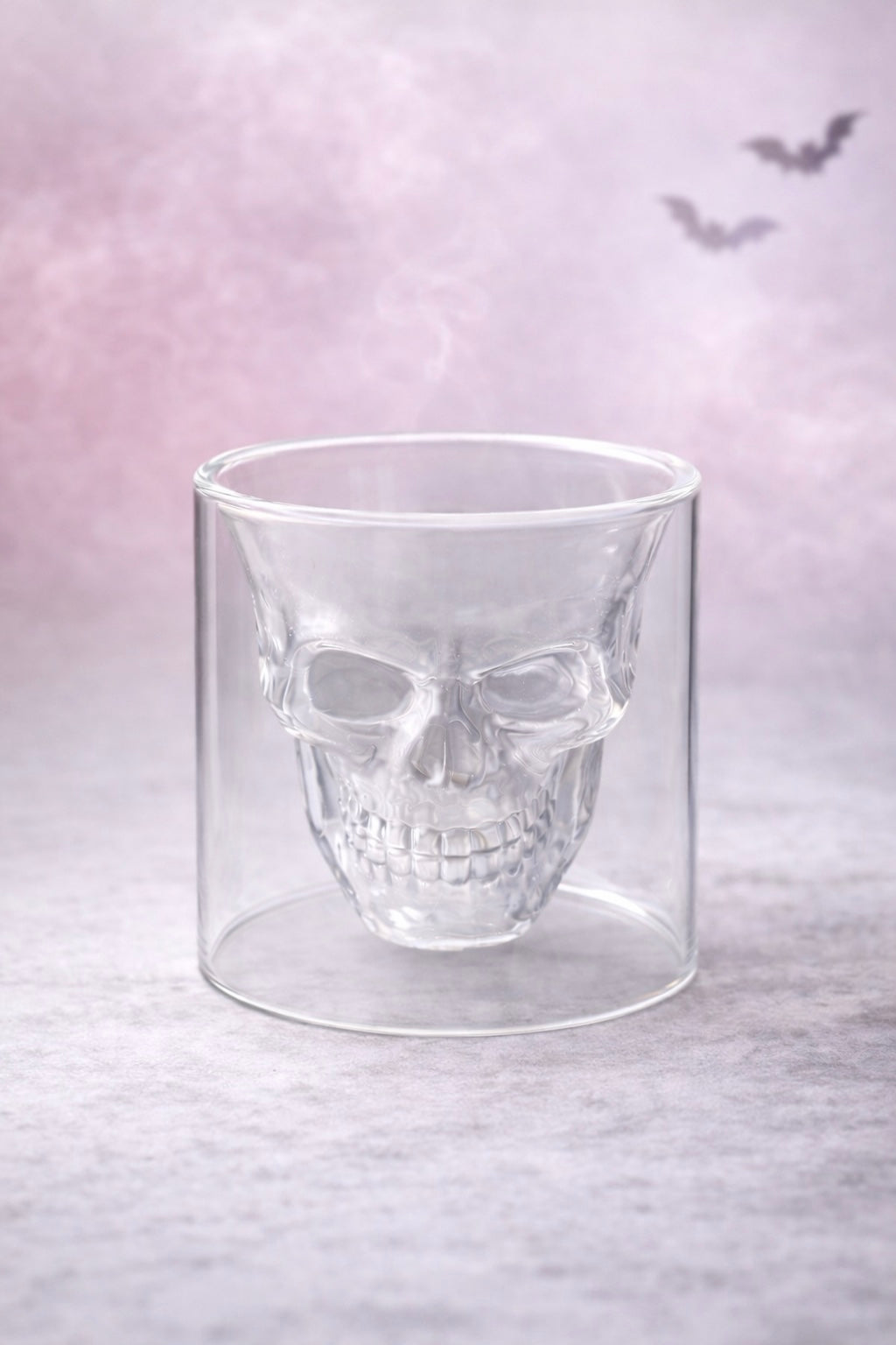 Glass skull vessel on a light purple background with bats.