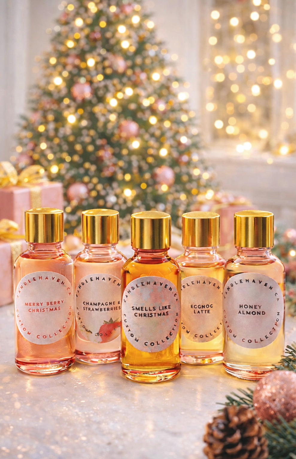 Five small bottles of candle making fragrance oil with gold caps on a decorative surface with a Christmas tree in the background.
