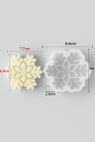 Snowflake-shaped cookie cutter with measurements on a gray background
