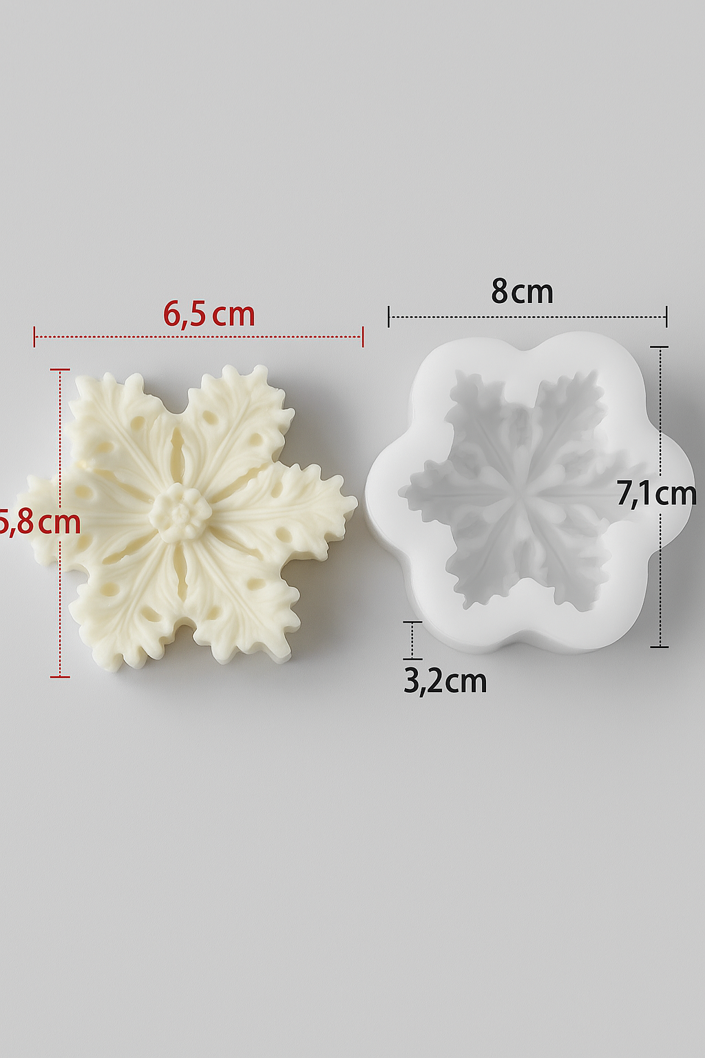 Two snowflake-shaped cookie cutters with measurements on a gray background