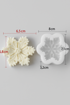 Two snowflake-shaped cookie cutters with measurements on a gray background