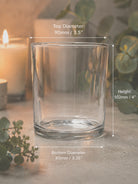 Clear glass candle holder with dimensions labeled on a neutral background