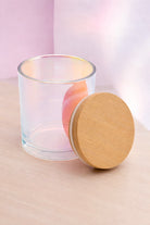 Iridescent Candle Vessel with Bamboo Lid On a soft pink minimalist background 