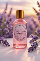 Bottle of 'Lavender Fields Forever' fragrance oil by Candlehaven with lavender flowers in the background