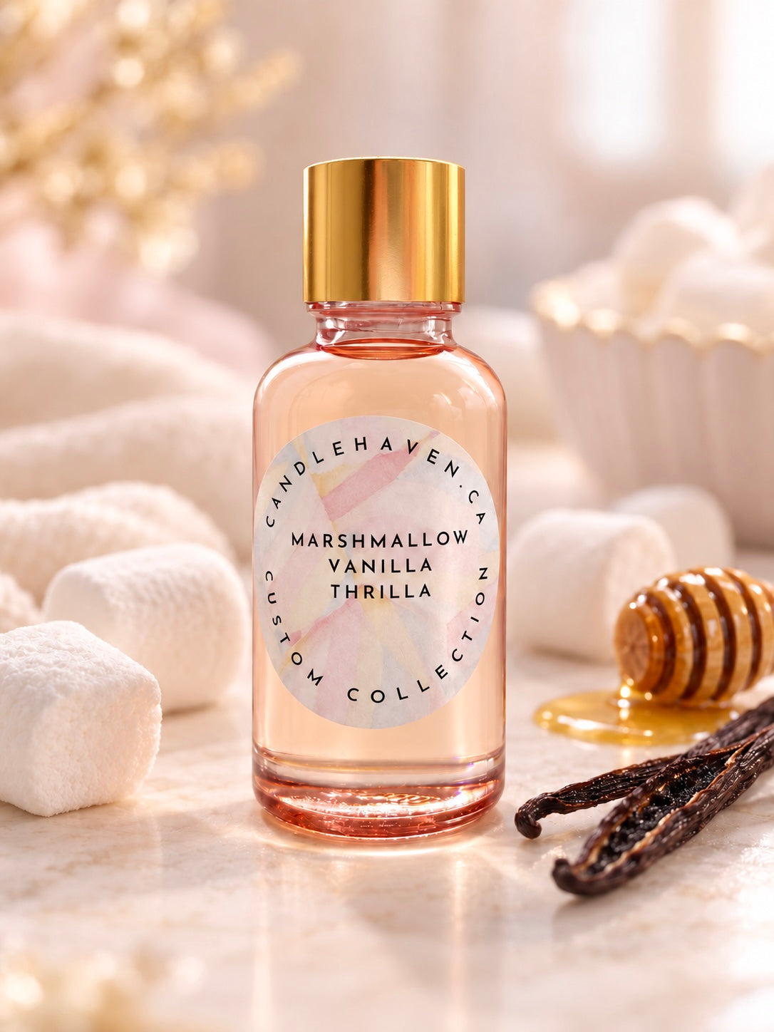 A glass bottle of Candlehaven Custom Collection 'Marshmallow Vanilla Thrilla' candle with a gold cap and white label, styled on a marble surface with marshmallows, vanilla beans, and honey.