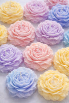 Peony shaped candles on a white background